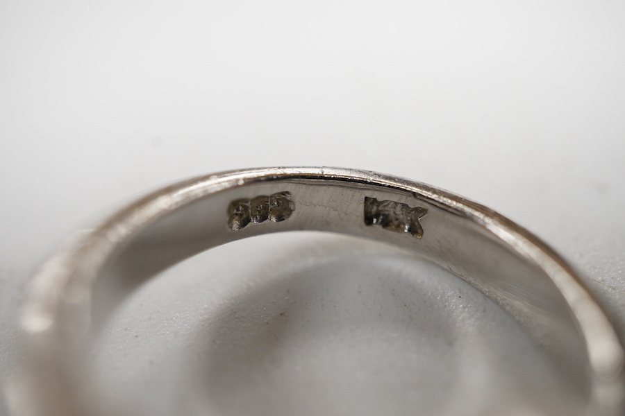 A recent 14k white metal and diamond ring, the ring head designed as three bands, central row of seven graduated diamonds, with two outer collet set diamonds, size G/H.